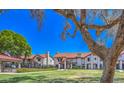Beautifully maintained townhouse community featuring lush green lawns, mature shade trees, and well-kept landscaping at 6262 E Brown Rd # 65, Mesa, AZ 85205
