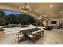 Spacious covered patio featuring a dining table and lounge area overlooking the pool at 6852 E Fanfol Dr, Paradise Valley, AZ 85253
