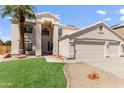 Charming two-story home featuring a three car garage, desert landscaping and green grass at 7326 W Pershing Ave, Peoria, AZ 85381