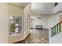 Bright open foyer with high ceilings, decorative tile flooring, and a view into the living room at 7326 W Pershing Ave, Peoria, AZ 85381