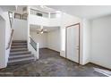 Bright foyer with high ceilings, decorative tile flooring, and a staircase leading to the second floor at 7326 W Pershing Ave, Peoria, AZ 85381