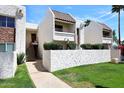 Charming condo exterior featuring clean lines, desert landscaping, and tiled roof, perfect for low-maintenance living at 7350 N Via Paseo Del Sur -- # Q105, Scottsdale, AZ 85258