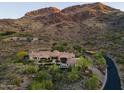 Breathtaking aerial view of the private estate nestled against a mountain backdrop and desert landscape at 7801 N Saguaro Dr, Paradise Valley, AZ 85253