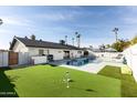 Expansive backyard with pool, putting green and outdoor kitchen at 8132 E Valley View Rd, Scottsdale, AZ 85250