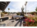 Inviting outdoor patio area featuring comfortable seating and lush landscaping at 8132 E Valley View Rd, Scottsdale, AZ 85250