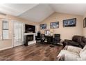 Bright living room featuring wood floors, a vaulted ceiling, and a charming fireplace at 820 W University Dr # 4, Tempe, AZ 85281