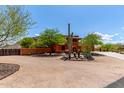 Inviting two-story home with desert landscaping, mature trees, and mountain views at 9137 E Odessa St, Mesa, AZ 85207