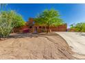 Charming two-story home with desert landscaping, beautiful trees and concrete driveway at 9137 E Odessa St, Mesa, AZ 85207