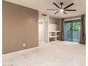Relaxing primary bedroom with carpeted floors, ceiling fan, and access to the outdoor patio at 9750 N Monterey Dr # 21, Fountain Hills, AZ 85268
