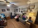 Cozy living room with a ceiling fan, wood flooring, and decorated with lots of personal touches at 10833 N 43Rd Dr, Glendale, AZ 85304