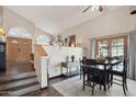Cozy dining area with wooden floors, a ceiling fan, and a seamless transition from the entry way at 11021 N 64Th Ln, Glendale, AZ 85304