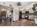 Well-lit kitchen boasts modern appliances, granite countertops, a pantry, and wood-look flooring at 11021 N 64Th Ln, Glendale, AZ 85304