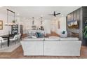 Open-concept living space with modern decor, a cozy fireplace, and seamless flow to the adjacent kitchen at 11705 W Luxton Ln, Avondale, AZ 85323