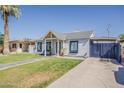 Charming home featuring a lush lawn, sidewalk, driveway, and painted window and trim accents at 1422 E Windsor Ave, Phoenix, AZ 85006