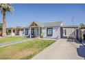 Inviting home with a green lawn, driveway, sidewalk, and painted window trim at 1422 E Windsor Ave, Phoenix, AZ 85006