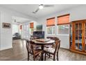 Bright dining area with warm colors, a piano, and a connection to the living area at 15360 W Corrine Dr, Surprise, AZ 85379