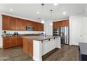 Modern kitchen with stainless steel appliances, a center island, and ample cabinet space, ideal for cooking at 15360 W Corrine Dr, Surprise, AZ 85379