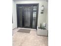 Modern entryway with a decorative glass door, stylish light fixture, and potted succulent at 4571 S Pinaleno W Dr, Chandler, AZ 85249