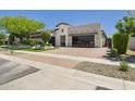 Charming home featuring a paved driveway, manicured greenery, and a modern design at 4571 S Pinaleno W Dr, Chandler, AZ 85249