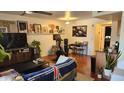 A cozy living room with hardwood floors, bright walls, and a shelf filled with wall art at 740 W Elm St # 264, Phoenix, AZ 85013