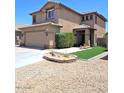 A charming two-story home showcasing a well-manicured front yard and appealing curb appeal at 8769 W Shaw Butte Dr, Peoria, AZ 85345