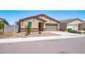 Charming single-story home featuring a two-car garage and low-maintenance desert landscaping at 12474 W Glenn Ct, Glendale, AZ 85307