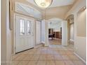Inviting foyer with decorative glass door, and tile floors, leading to an open office area at 14999 W Mulberry Dr, Goodyear, AZ 85395