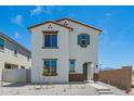 Two-story home with white exterior, brown trim, a green front door, minimal landscaping, and a concrete pathway at 15622 S 181St Dr, Goodyear, AZ 85338
