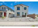 A two-story white home featuring brown trim, a green door, minimal landscaping, and a welcoming concrete path at 15622 S 181St Dr, Goodyear, AZ 85338