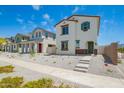 Two-story home with white exterior, brown trim, a green door, minimal landscaping, and a concrete walkway at 15622 S 181St Dr, Goodyear, AZ 85338
