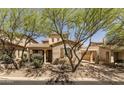 Charming home exterior with a carport, desert landscaping, and neutral color palette at 18267 N 95Th St, Scottsdale, AZ 85255