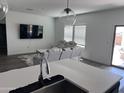 Open living area with a kitchen island featuring a modern sink and stainless steel appliances at 3023 W Bent Tree Drive Dr # 3023, Phoenix, AZ 85083