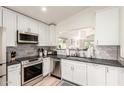 Modern kitchen with white cabinets, stainless steel appliances, and sleek countertops at 3269 E San Remo Ave, Gilbert, AZ 85234