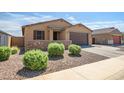 Charming single-story home with a well-manicured yard, stone accents, and a two-car garage at 37101 N Andravida Dr, San Tan Valley, AZ 85140