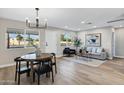 Inviting living room with wood floors, stylish furnishings, and large windows for natural light at 7149 E Jensen St, Mesa, AZ 85207