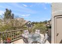 Enjoy beautiful views from this private patio with a glass table and comfortable striped chairs at 7272 E Gainey Ranch Rd # 48, Scottsdale, AZ 85258