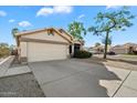 This single-story home features a two-car garage and low maintenance landscaping at 1024 N Ithica Ct, Chandler, AZ 85225