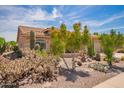 Home exterior with desert landscaping and a variety of cacti at 10861 E Olla Ave, Mesa, AZ 85212