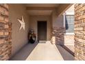 Inviting entryway with brick accents, covered porch, and decorative star at 1194 E Coyote Creek Way, San Tan Valley, AZ 85143