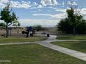 Community playground with play structures, picnic tables, and green spaces at 1194 E Coyote Creek Way, San Tan Valley, AZ 85143