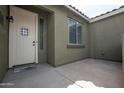Inviting front entrance with a white door, window, and decorative wall-mounted lamp at 14091 W Bloomfield Rd, Surprise, AZ 85379