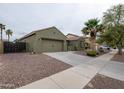 Single-Gathering home featuring desert landscaping, a two-car garage, and secure fencing at 14091 W Bloomfield Rd, Surprise, AZ 85379