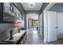Stylish hallway with tiled flooring, modern decor, and an open doorway to the living area at 14091 W Bloomfield Rd, Surprise, AZ 85379