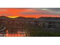 Picturesque sunset reflecting off the lake behind the community and illuminating the mountain backdrop at 16226 S 11Th Pl, Phoenix, AZ 85048