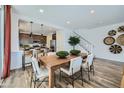 Open-concept dining area with wood table and modern decor at 16377 W Weeping Willow Rd, Surprise, AZ 85387