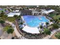 Stunning aerial view of community pool and amenities, including ample seating and lush landscaping at 16842 W Bronco Trl, Surprise, AZ 85387