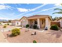 Attractive single-story home featuring desert landscaping, a covered porch, and a welcoming facade at 18031 W Udall Dr, Surprise, AZ 85374