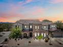 Two-story home boasting a tile roof, stone accents, and a well-maintained front yard under a beautiful sunset sky at 20750 N 87Th St # 2038, Scottsdale, AZ 85255