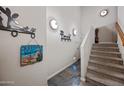 Hallway view with staircase featuring unique wall decor and slate floors at 20750 N 87Th St # 2038, Scottsdale, AZ 85255