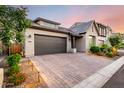 A single-story home with a spacious driveway, two-car garage, and professionally landscaped yard at 21127 W Minnezona Ave, Buckeye, AZ 85396